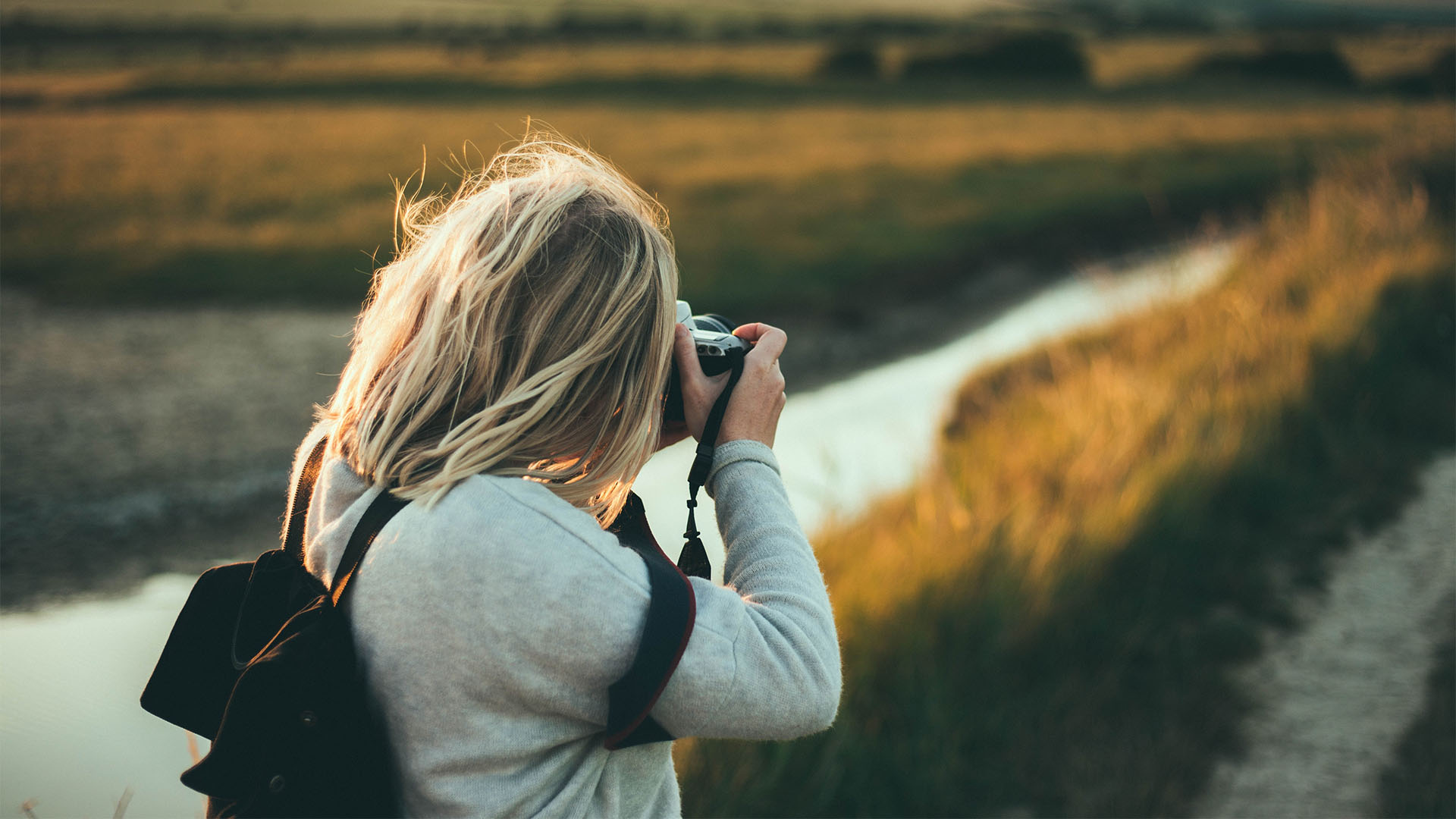 Person taking landscape photos outside.